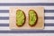 Guacamole sandwich on light background avocado sandwiches on wooden board and textile top view