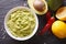 Guacamole sauce with ingredients close-up. horizontal top view