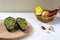 Guacamole sauce in peel from avocado with ingredients on a wooden background. Healthy eating Vegetarian food