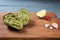 Guacamole sauce in peel from avocado with ingredients on a wooden background. Healthy eating Vegetarian food