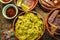 Guacamole and tortilla chips in vintage red clay pots