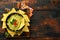 Guacamole. Traditional latinamerican Mexican dip sauce in a black bowl with avocado and ingredients and corn nachos. Avocado