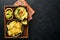 Guacamole. Traditional latinamerican Mexican dip sauce in a black bowl with avocado and ingredients and corn nachos. Avocado