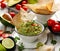 Guacamole, traditional Mexican dip made of avocado, onion, tomatoes, coriander, chilli peppers, lime and salt with the addition o