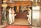 Guangzhou, China - July 22, 2018: Beautiful girls at the entrance to a Chinese restaurant offering a menu to guests.