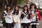 Guangzhou, China - MARCH 15, 2016: Four Chinese smiling pretty student girls in school wear with flowers