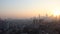 Guangzhou. Time lapse of dawn. There are small and tall houses. There are cars on the road below.