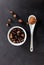 Guarana seeds and powder in porcelain bowl and spoon