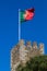 Guard castle tower Castelo de S. Jorge with the Portuguese flag, Lisbon