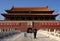 A guard standing in Tiananmen Square in front of the Gate of Heavenly Peace.