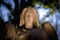 Guardian angel against dark background. fragment of an antcient statue