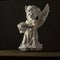 Guardian angel  black background statue copy space beautiful holy wings bowl of roses flower in hand