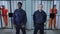 Guards stand in the background of prison cells