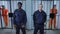 Guards stand in the background of prison cells