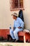 Guatemalan cowboy rests on a church bench