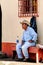 Guatemalan cowboy rests on a church bench