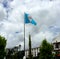 Guatemalan flag under a blue sky in Paseo CayalÃ¡