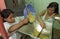 Guatemalan Indian girls grinding maize in a mill