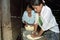 Guatemalan teens knead ground corn into dough