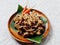 Gudeg, traditional Indonesian food, on a wooden plate and banana leaf