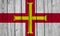 Guernsey Flag Over Wood Planks