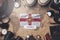 Guernsey Flag Between Traveler`s Accessories on Old Vintage Map. Overhead Shot