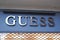 Guess logo facade and sign text on storefront wall entrance shop luxury clothing American