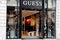 Guess storefront text and logo shop sign of facade store store luxury clothing