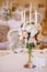 Guest tables with candlestick in rich decorated wedding banquet room