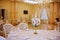 Guest tables with candlestick in rich decorated wedding banquet room