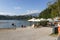 Guests and residents of Bled relax on the lake