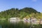 Guests and residents of Bled relax on the lake