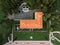 Guests in white at a wedding on the lawn in front of Villa Milocer. Top view