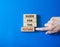 Guide for the future symbol. Wooden blocks with words Guide for the future. Businessman hand. Beautiful blue background. Business