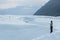 Guide on an icy slope overlooking the Chugach Mountains on the Matanuska Glacier in Alaska