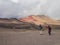 Guide points at tourist as they go up the seven colors mountain