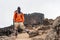 Guide stands before Lava Tower in Mt. Kilimanjaro