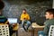 Guiding the young generation to success. Portrait of male teacher listening to his pupils, while sitting with tablet pc