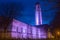 The Guildhall at night, illuminated purple.