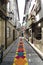 Guimaraes, Braga, Portugal. August 14, 2017: Narrow cobblestone alley with very colorful ornaments formed by small papers in its c