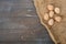 Guinea fowl eggs located on burlap on wooden dyed background.