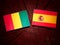 Guinean flag with Spanish flag on a tree stump