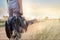 Guitar bag in hand on countryside road in nature background