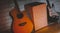 Guitar and cajon in the room with wooden background.