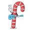 With guitar candy canes mascot cartoon