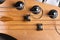 Guitar fretboard with tuning pegs and strings on a gray background. Close-up