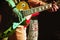 Guitar in the hands of a guitarist standing on stage in spotlight