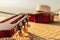 Guitar and hat on reed mat near the sea at sunset. Travel, vocation, holiday, summer concept