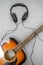 Guitar, headphones, silhouette of a guitarist playing