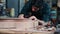 Guitar luthier carefully places the back of guitar in mold